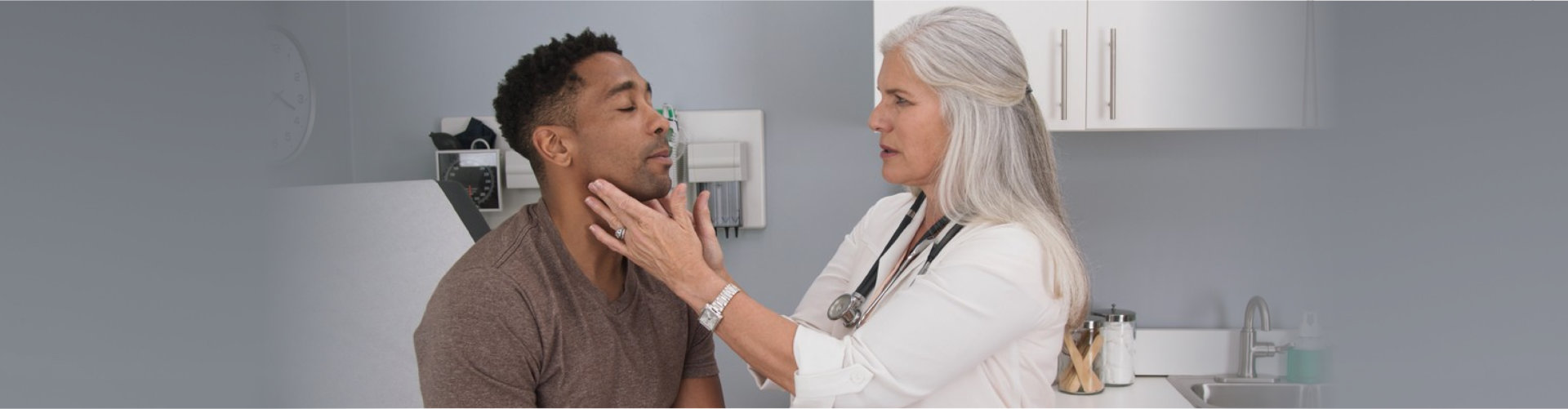 Attractive male having doctor checkup at health clinic