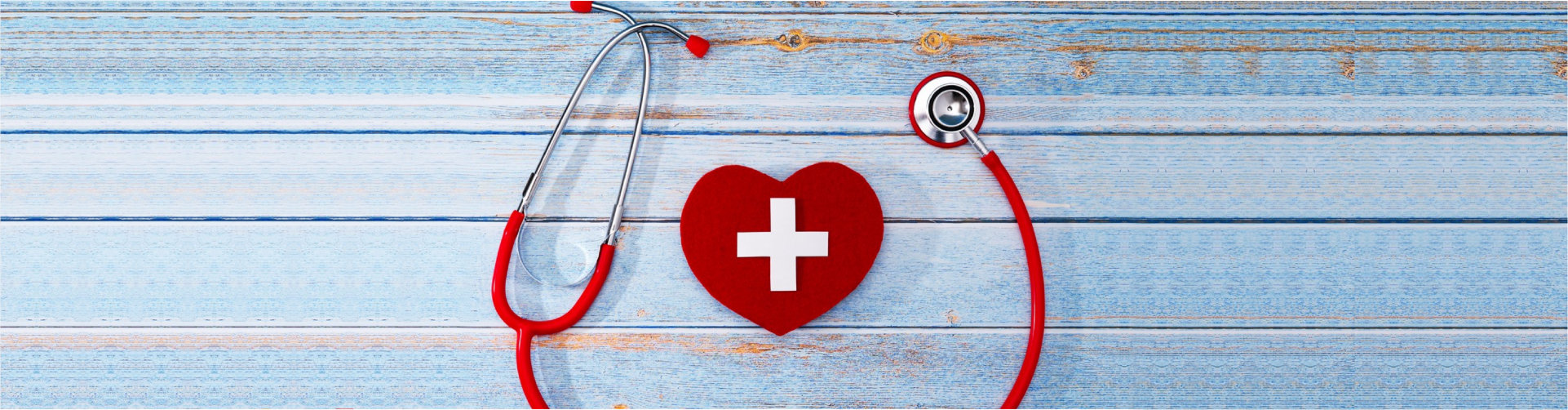 World Red Cross day. Red heart with Stethoscope on wooden table background